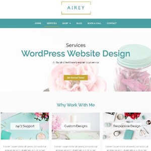 May include: Website design services offered by Airey. The website features a light blue and white color scheme with a pink flower and a glass jar with pink paper clips. The text "WordPress Website Design" is displayed in a large font size. The text "Why Work With Me" is displayed in a smaller font size. Three service options are listed: 24/7 Support, Custom Designs, and Responsive Design.