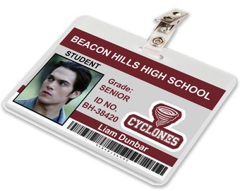 May include: A white plastic student ID card with a red and white logo for Beacon Hills High School. The card has a photo of a young man, the text "STUDENT", "Grade: SENIOR", "ID NO. BH-38420", "CYCLONES", and "Liam Dunbar".