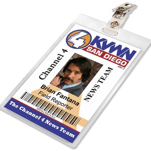 May include: A white plastic ID badge with a blue and yellow logo for Channel 4 KWWN San Diego AM-3. The badge has a photo of a man with a mustache and the text "Brian Fantana Field Reporter" and a barcode. The badge has a clip on the top.