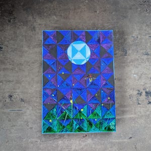 May include: A rectangular canvas painting featuring a geometric pattern of blue and purple triangles. A large, light blue circular moon sits at the top center. Small yellow dots represent fireflies, with one larger firefly depicted in flight.