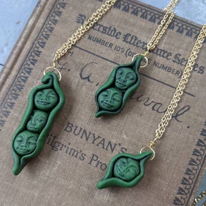 Handmade polymer clay peas in a pod face necklace