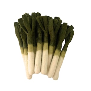 May include: A bunch of felt leeks with green tops and white bottoms. The leeks are arranged in a cluster, with the tops pointing upwards.