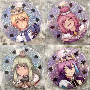 May include: Four round, holographic, glitter buttons featuring anime characters wearing crowns and royal attire. Each button has a different character with a different colored crown and outfit. The characters are all smiling and have different hairstyles. The buttons are all set against a white background.