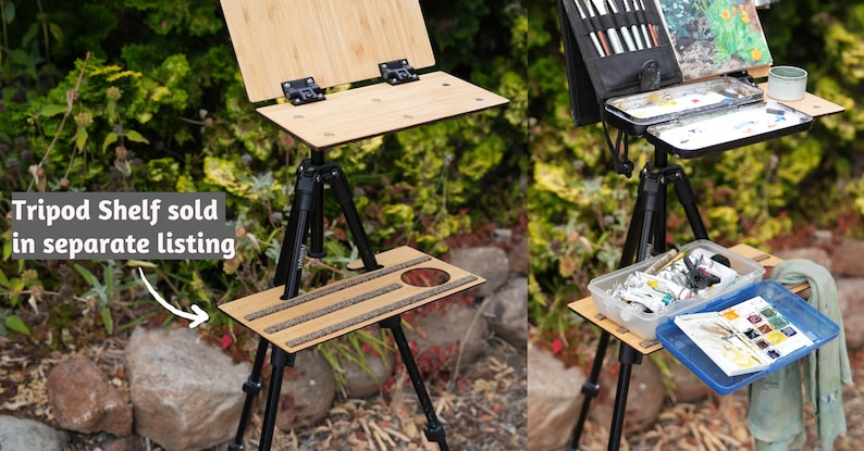 May include: A wooden easel with a tripod stand and a shelf for supplies. The easel is set up outdoors on a grassy surface. The shelf is sold separately.