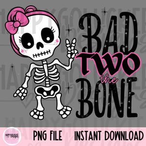 May include: A pink and white skeleton girl with a pink bow in her hair, holding up two fingers. The text "Bad Two the Bone" is in black with glitter accents.
