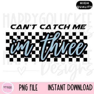 May include: A black and white checkered background with the text "Can't Catch Me I'm Three" in blue lettering.
