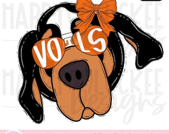 May include: A cartoon illustration of a dog's face with orange sunglasses that read "VOLS". The dog has a brown snout, black ears, and an orange bow. The image also includes the text "PNG FILE" and "INSTANT DOWNLOAD".