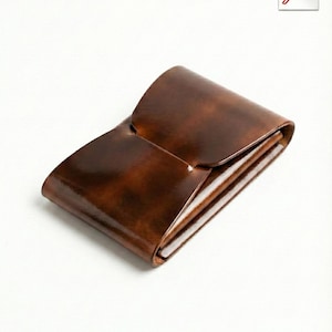 May include: A brown leather wallet with a glossy finish. The wallet is folded and has a flap closure. The interior appears to have multiple compartments. The design is minimalist and elegant, suitable for carrying cards and cash.