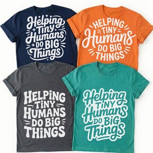 May include: Four t-shirts in navy blue, orange, charcoal gray, and teal. Each shirt features the white text "Helping Tiny Humans Do Big Things" in a whimsical font. The shirts have rolled sleeves and a crew neck.