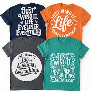 May include: Four t-shirts in navy, orange, charcoal, and teal. Each shirt features the phrase "Just Wing It. Life. Eyeliner. Everything" in white, stylized text. The shirts have rolled sleeves and a crew neck.