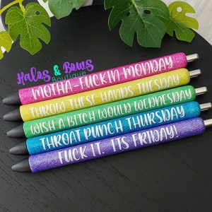 May include: Set of six glitter pens with black caps. Each pen has a different color and a funny saying about the days of the week. The sayings are: "Motha-F*ckin Monday", "Throw These Hands Tuesday", "Wish A Bitch Would Wednesday", "Throat Punch Thursday", "F*ck It. It's Friday!"