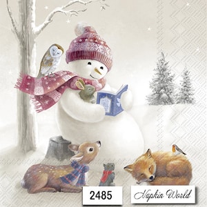 May include: A snowman wearing a pink and white hat and scarf is reading a book.  The snowman is surrounded by a white owl, a brown rabbit, a brown deer, a gray cat, and a brown fox.  The image has the text "Napkin World" and "2485" on it.
