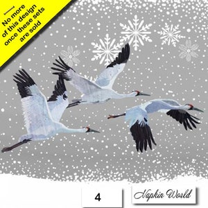 May include: Three white cranes with black wingtips fly against a gray background with white snowflakes. The text "Napkin World" and the number "4" are visible at the bottom of the image.