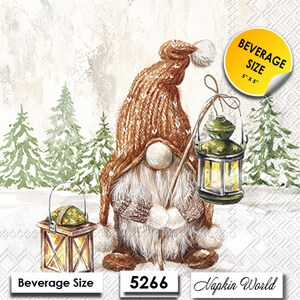May include: A brown gnome with a white beard and a brown knit hat holds a lantern in a snowy forest setting. The lantern is lit and has a yellow glow. The gnome is standing on a snowy path with pine trees in the background. The text "Beverage Size 5" x 5" " is visible in the upper right corner of the image.