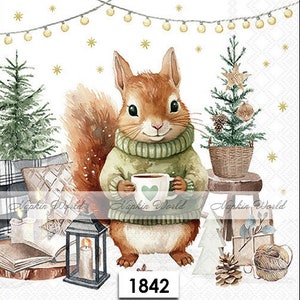May include: A watercolor illustration of a squirrel wearing a green sweater and holding a cup of coffee. The squirrel is sitting in front of a small Christmas tree and a lantern. The image has a white background with a string of lights and stars.