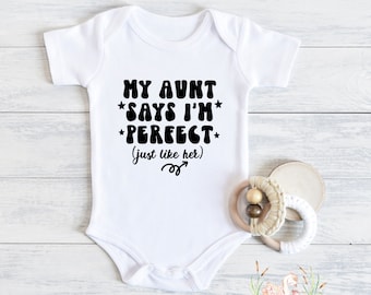 May include: White baby onesie with black text that reads "My Aunt *Says I'm* *Perfect* (just like her)".