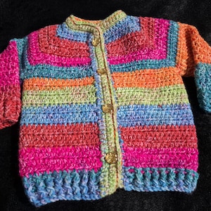 Hand crocheted, OOAK easy care acrylic baby or toddler cardigan in vibrant rainbow tones sized to fit 6 to 18 months old.
