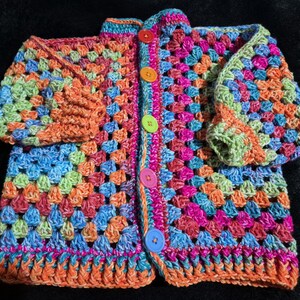 Hand crocheted, OOAK easy care acrylic baby or toddler cardigan in vibrant rainbow tones sized to fit 18 months to 4 years old.