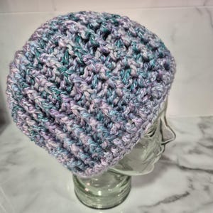 Large to XL adult, unisex, chunky, hand crocheted beanie in variegated tones of blue, mauve, grey and green.