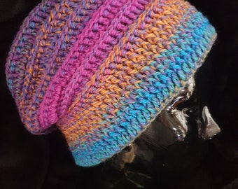 Small to Medium adult, unisex, crochet slouch hat made with 100% BWM wool in rainbow tones.