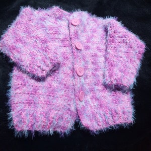 Extra soft, hand crocheted, girl&#39;s cardigan in candy pink tones sized to fit 18 months to 3 years old.