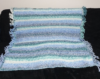 Beautiful green toned crocheted blanket or throw with fringe for that special person.