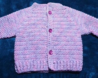 Gorgeously soft, mauve and pink variegated cotton acrylic mix baby cardigan sized to fit a newborn to 6 months.