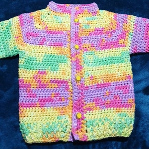 Hand made cotton baby cardigan in gorgeous rainbow tones to fit 6 to 12 month old.