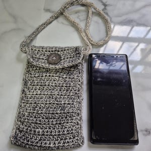 Hand crocheted 100% cotton mobile phone holder with neck strap available in different colours.
