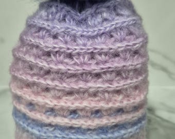 Hand crocheted baby beanies with matching pompoms for size 00 to 6 months in different colours.