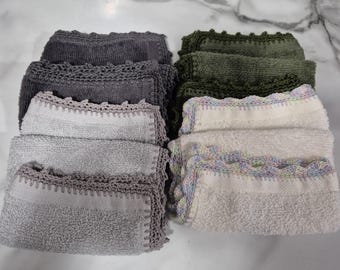May include: A set of six kitchen towels, each with a different color and pattern. The towels are made of a soft, absorbent material and have a crocheted border. The colors include gray, green, and white.