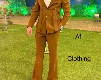 May include: A brown suit with a unique design featuring a belt that wraps around the waist and ties at the front. The suit has a double-breasted jacket and flared pants.