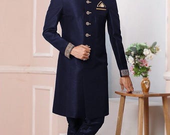 May include: Navy blue formal suit with a mandarin collar and ornate gold trim. The long coat features decorative buttons and a pocket square. The text "Af cloth" is visible in the upper left corner. The suit is paired with matching trousers and black shoes.