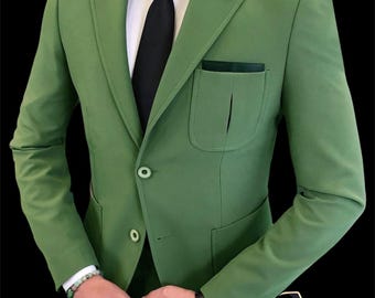 May include: A green suit with a white dress shirt and black tie. The suit has a two-button closure and a pocket square. A watch and bracelet are visible. The text "AFFASHION MEN'S WOMEN COLLECTION" is in the lower right corner.