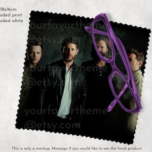 May include: A microfiber cleaning cloth featuring a black and white photo of four men. The cloth is 18 inches by 16 inches and is printed on one side.