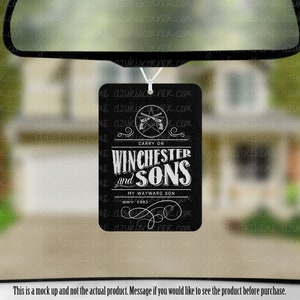 May include: Black and white car air freshener with the text "Carry On Winchester and Sons My Wayward Son Est. 1983" and a graphic of two pistols crossed over a pentagram.