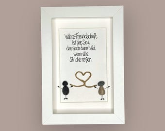 May include: A framed artwork with a white border. The artwork features two pebble figures holding a heart-shaped rope. The text in the image reads "True friendship is the rope that holds even when all ropes break."