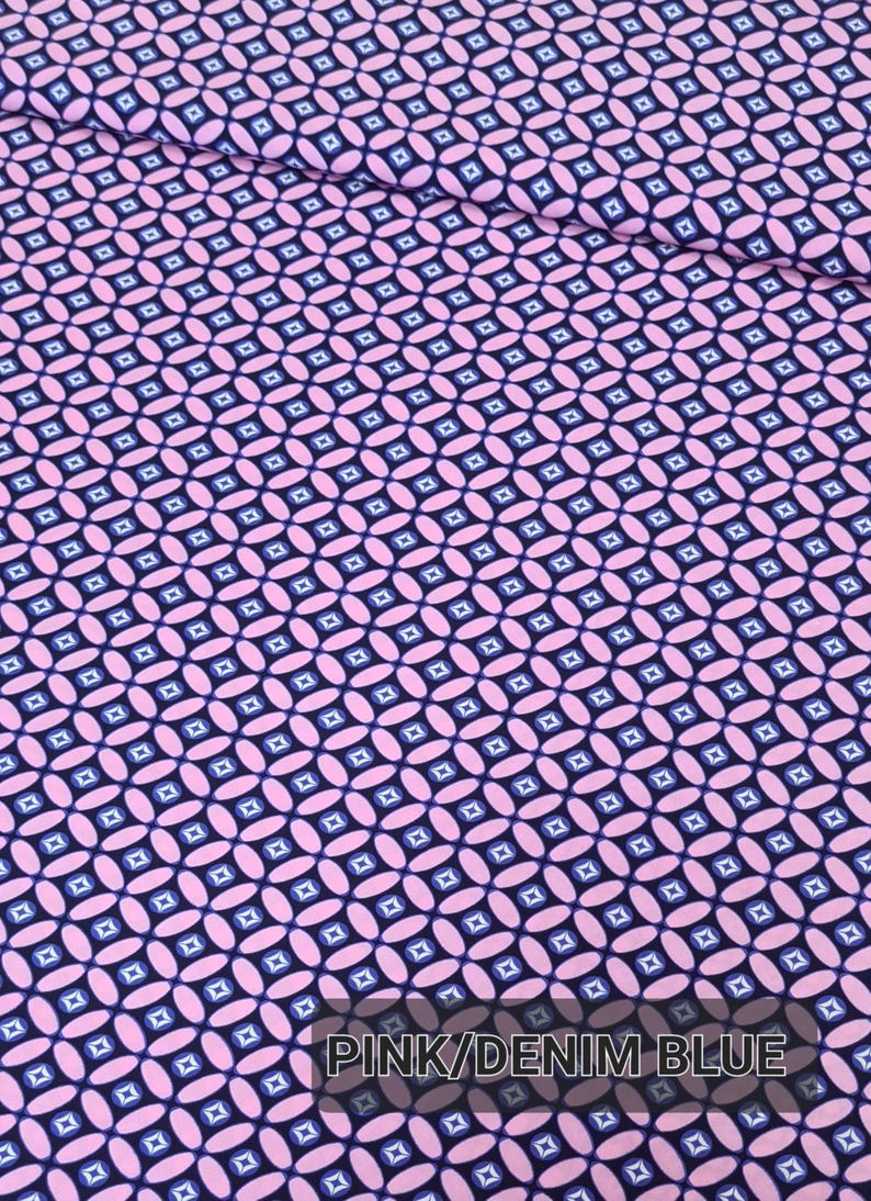 May include: Pink and denim blue fabric with a repeating pattern of small squares and ovals.