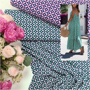 May include: A close-up of a green and white fabric with a geometric pattern. The fabric is folded and draped over a bouquet of pink roses. The fabric is also shown on a woman wearing a maxi dress.