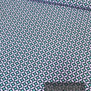 May include: Lilac and green geometric fabric with a repeating pattern of small squares and ovals. The fabric has a black background.