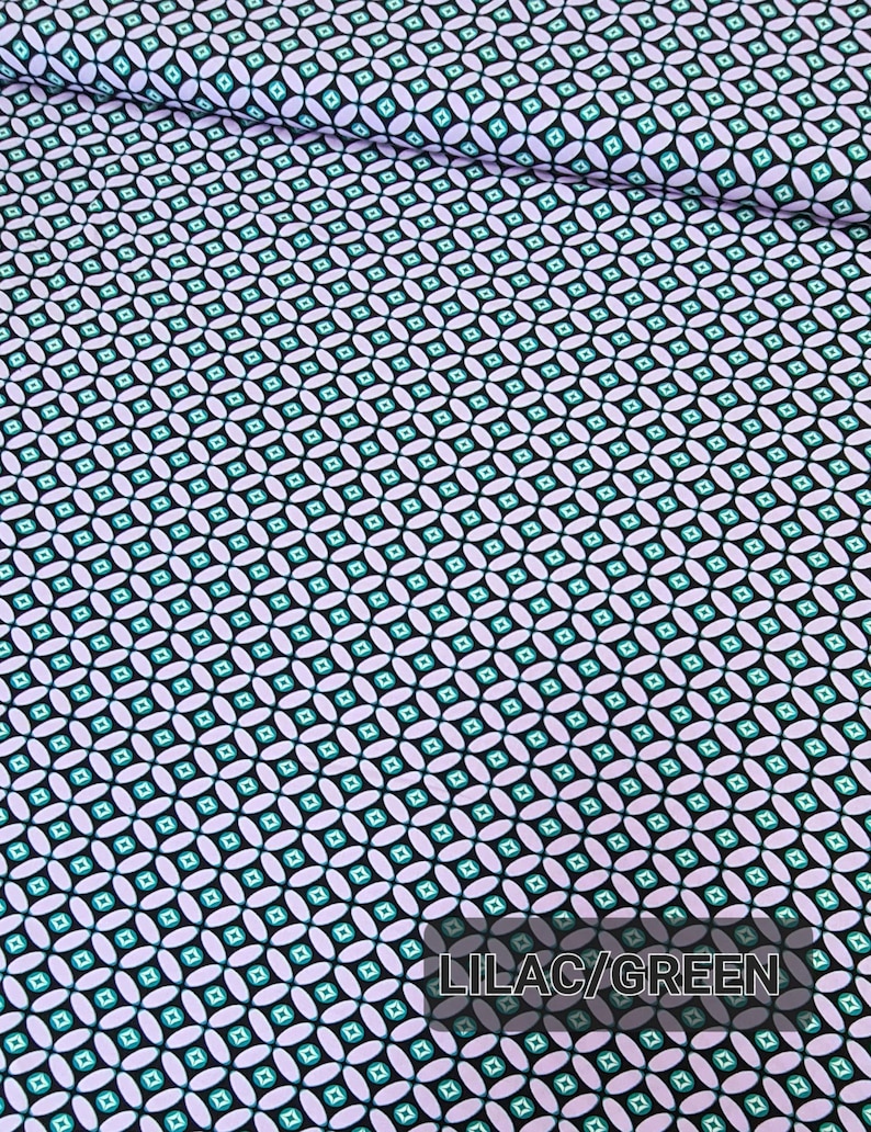 May include: Lilac and green geometric fabric with a repeating pattern of small squares and ovals. The fabric has a black background.