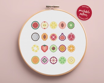 May include: A white embroidery hoop with a colorful cross-stitch pattern of various fruits, including watermelon, apple, lemon, peach, kiwi, coconut, fig, pomegranate, strawberry, avocado, passion fruit, orange, lime, and melon. The hoop is on a pink background with the text "INSTANT PRINTABLE PATTERN DOWNLOAD" in a red circle.