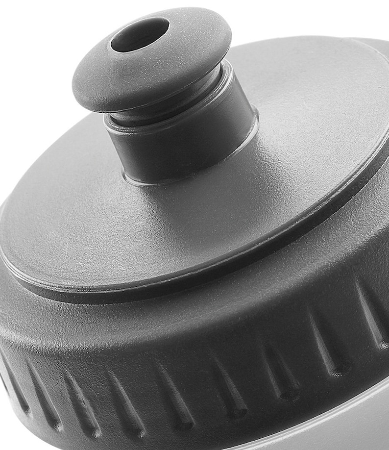 May include: Close-up of a gray plastic water bottle cap with a textured surface and a small opening for drinking.