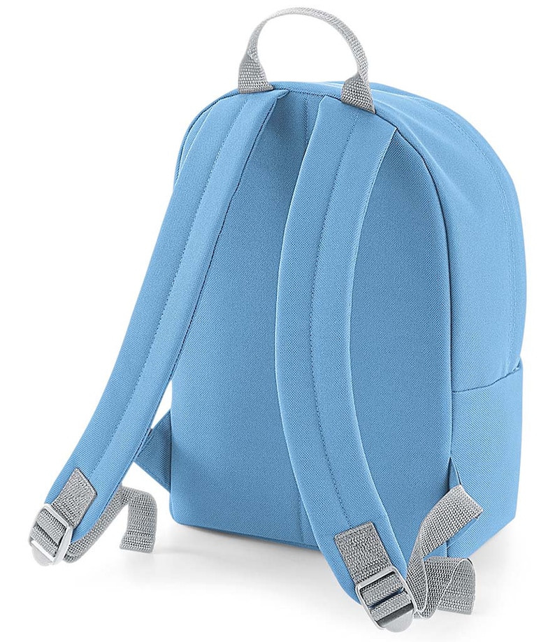 May include: A light blue backpack with gray straps and a gray handle. The backpack has a rounded shape and a zippered closure.