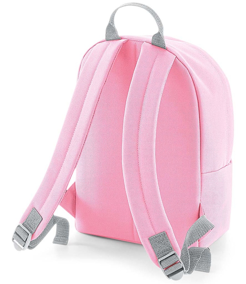 May include: A pink canvas backpack with gray adjustable straps and a gray top handle.