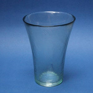Very old vase made of thick glass with an interesting texture. Clear signs of manual processing. Transparent with a greenish reflection