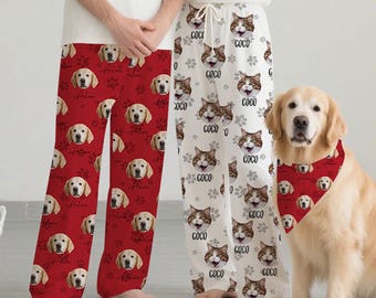 May include: Red pajama pants with a repeating pattern of golden retriever faces, paw prints, and the name "Arlene". White pajama pants with a repeating pattern of cat faces and the name "Coco". A golden retriever dog wears a matching red bandana.