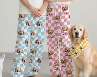 May include: Matching pajama pants with a dog face pattern. One pair is light blue with a checkerboard pattern, and the other is pink. A golden retriever dog wears a matching bandana.