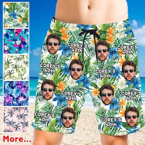 May include: Floral print swim trunks with a drawstring waist. The trunks feature a pattern of tropical flowers and leaves, with faces and the text "COREY'S 40th" repeated throughout. The trunks are knee-length.