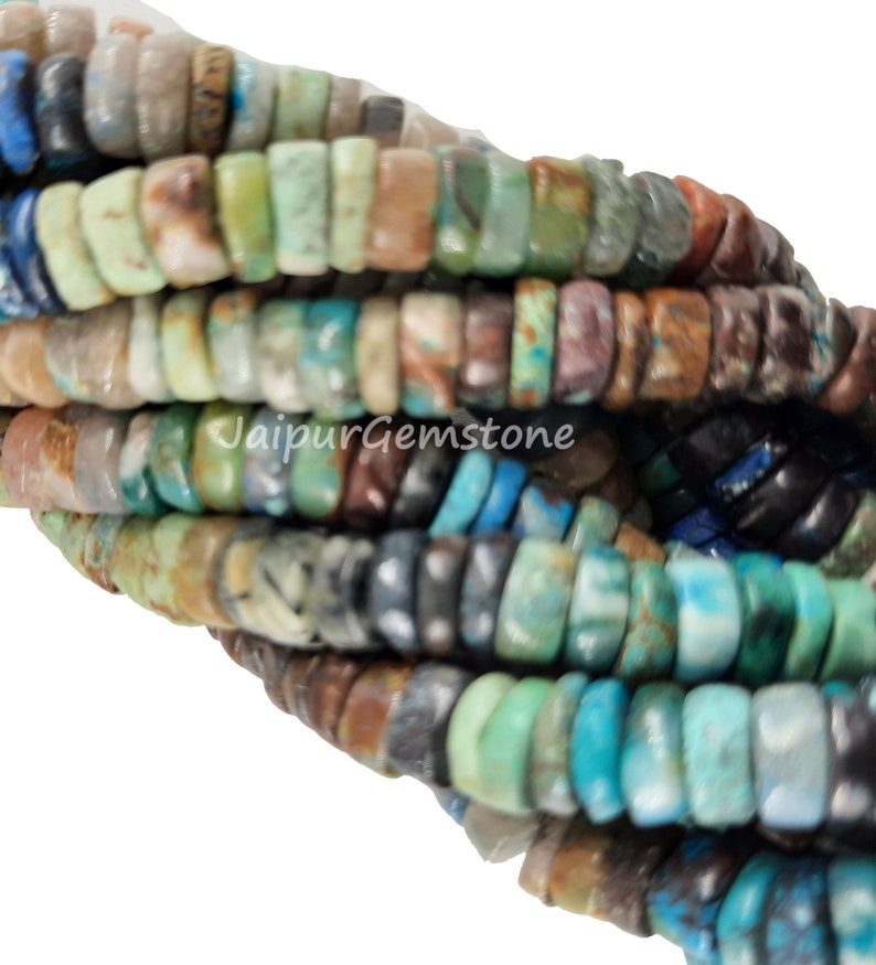 May include: A strand of multi-colored gemstone beads. The beads are small and round, and they are arranged in a random pattern. The colors of the beads include blue, green, brown, and white.